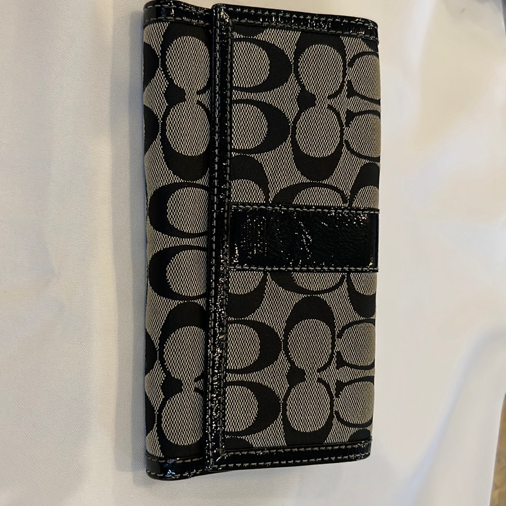 Coach wallet with lavender accent color.  Good condition. Zippered side.